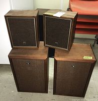 Four speakers are shown: two larger Sony floor-standing style with wooden cabinets and fabric grills and two smaller Ross shelf-style speakers also with wood and fabric. Speakers appear vintage with some wear.