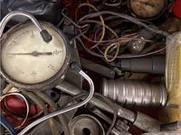 Close view of torque wrench dial gauge and connected air hoses.