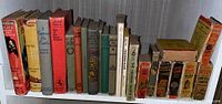 Full shelf view of vintage children's books showing multiple titles and sizes, colorful spines including red, yellow, green, orange, and beige.