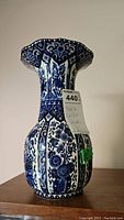 Full view of the Boch Delfts vase showing blue and white floral pattern and flared scalloped rim.