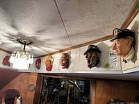 Seven Bossons heads mounted in a row on wall molding