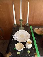 Overall shot showing the Belleek bowl, pitcher, plate and three-arm candelabra with candles.