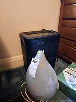 Humidifier and shredder side by side against wall and floor