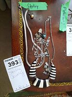Photo showing multiple sterling silver jewelry pieces: two striped necklaces, a charm bracelet with various charms, and a single stud earring. Also visible is a "Sterling" tape label.