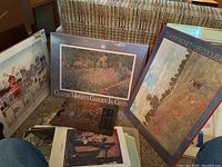 Photo showing multiple posters and prints including Claude Monet's Garden in Giverny and Les Coquelicots.