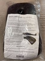 Back stretcher with user instructions clearly visible through plastic bag.