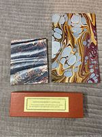 Photo of two small marbled notebooks and a brown box containing the bayberry candles.