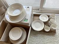 Overview of dinner plates, side plates, soup plates, cups, saucers arranged in boxes showing condition and quantity.