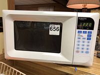 Front view of Emerson small microwave oven with digital keypad and display showing time 2:21.