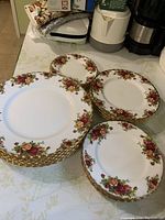 Three stacks of plates showing large dinner plates, medium salad plates, and small bread and butter plates