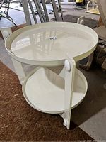 Front three-quarter view showing two circular trays and triangular frame on casters