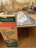 Photo of boxed Singer cutting board standing upright showing size 40x72 inches and description.