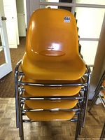 Front view of four stacked chairs