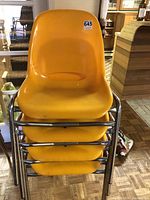 Front view of four stacked chairs