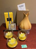 Lot contents showing the Nest Almalfi Lemon and Mint reed diffuser box, Aroma 400ml diffuser, and three glass candle bowls with flower designs.