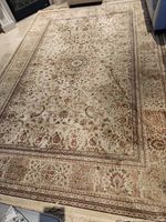 Full view of entire rug laid flat on floor, showing overall size, pattern, border and fringe.