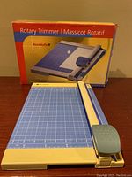 Rotary trimmer viewed with box in background showing full setup and packaging.