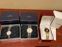 Three watches side by side in original Bulova and Wittnauer boxes