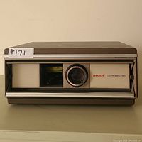 Front view of Argus Electromatic 560 slide projector with lens and branding visible.