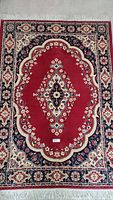 Full view of vintage red Nova area rug with central medallion and border patterns