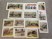 15 cartoon prints laid out on carpet, various scenes featuring dogs and bulldogs