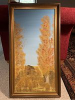 Full view of the framed acrylic painting showing the autumn landscape with a house and trees.