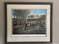 Framed print "Buddies" featuring two horses near a wooden fence with trees in the background, showing the full artwork in a brown frame.
