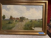 Front view of the framed oil painting showing the rural hay gathering scene with people, horses, and buildings under cloudy sky.