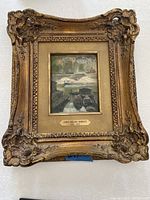 Frontal view of the gilt wood frame, engraved plaque, and central oil painting.