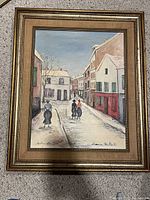 Front view of framed painting showing Montmartre street scene with figures and pastel-colored buildings