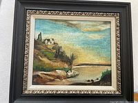 Front view of framed coastal landscape painting