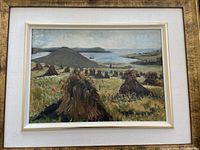 Frontal photo of framed oil painting titled 'Haystacks' showing a rural landscape with multiple haystacks, hills, and water body in the background.