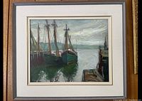 Framed oil painting showing three sailboats at harbor and dock
