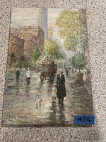 Front view of oil painting on canvas depicting a rainy urban street scene with figures, carriage, and signature 'Childe Hassam'