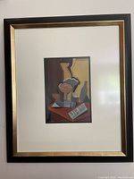 Full view of matted and framed cubist-style still life painting