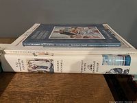 Stack of two Norman Rockwell art books, titled 'Norman Rockwell Illustrator' and 'Norman Rockwell Favorites'.