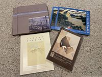 Photo of five art books including 'A Grand Eye for Glory' on A.J. Jackson, two copies of a J.E.H. MacDonald book, 'Living in Harmony' on Goodridge Roberts, and 'In Seclusion with Nature' on E.J. Kinsella.