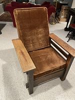 Front angle view of Morris Chair showing brown velvet cushions and wood armrests.