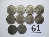 Top view of obverse sides of 10 Eisenhower Bicentennial one-dollar coins showing President Eisenhower profile, dated 1776-1976.