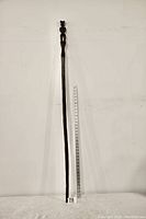 Full length photo of walking stick with measuring tape showing approximate length of 56.5 inches.