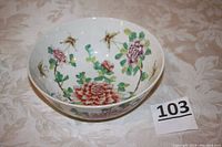 Top view of a white porcelain bowl showing detailed pink and red floral transfer and hand-painted design inside the bowl.