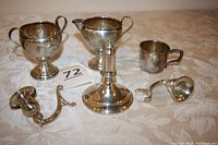 All pieces: sugar bowl, creamer, baby cup, candlestick holder parts