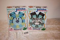 Two Nature Calls jumbo animal alarm clocks in original packaging, one dog and one raccoon design.