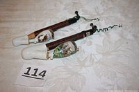 Two vintage German porcelain bowl smoking pipes with wood stems on fabric background, numbered 114