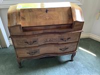 Front angled view of fruitwood inlaid secretary desk showing drop-front, curved drawer fronts and cabriole legs