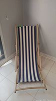Front view of beach chair showing wood frame and striped fabric seat