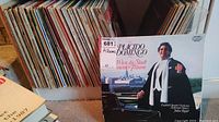Photo showing a collection of LP records stored vertically with a prominent Placido Domingo album in foreground.