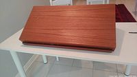 Closed view of teak veneer shelf on white table