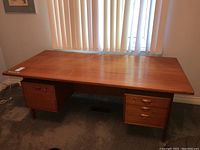 Front view of full desk showing top surface, storage units and overall design