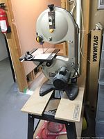 Front view of Ryobi band saw mounted on Craftsman work station, showing overall configuration.